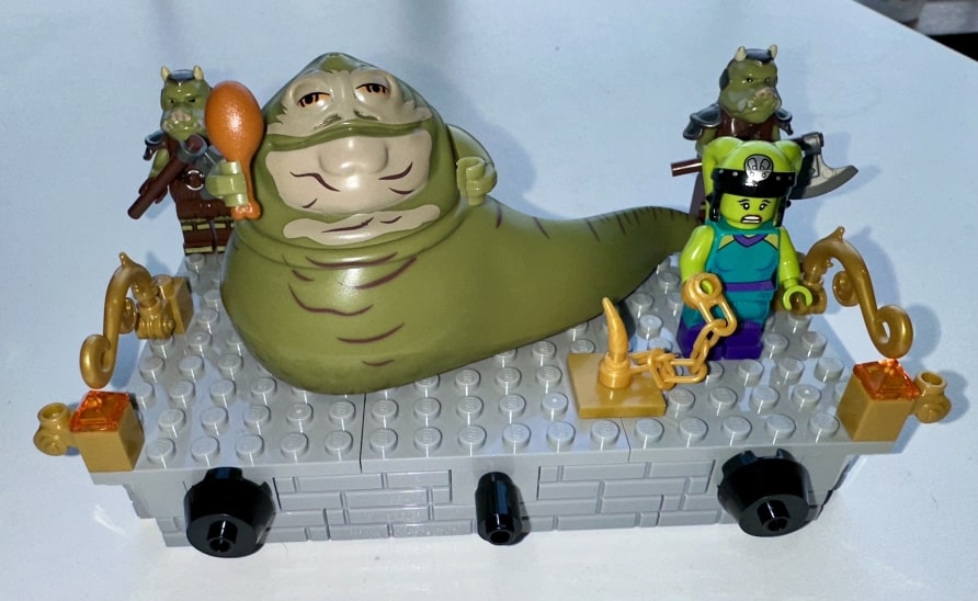 Jabba the Hutt in his throne room with a Twilek slave and Gamorrian guards.