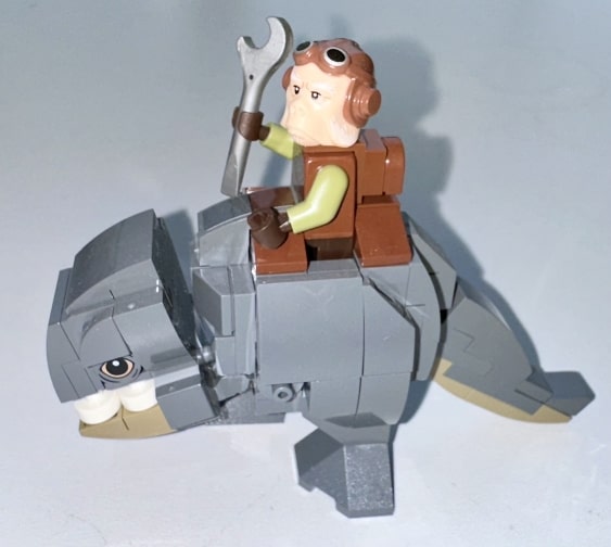 Ugnaught tech specialist riding a blurrg.